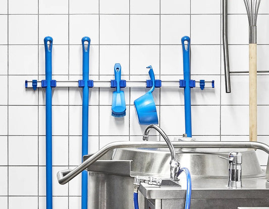 Commercial kitchen utensils organized on Toolflex wall-mounted storage rail system