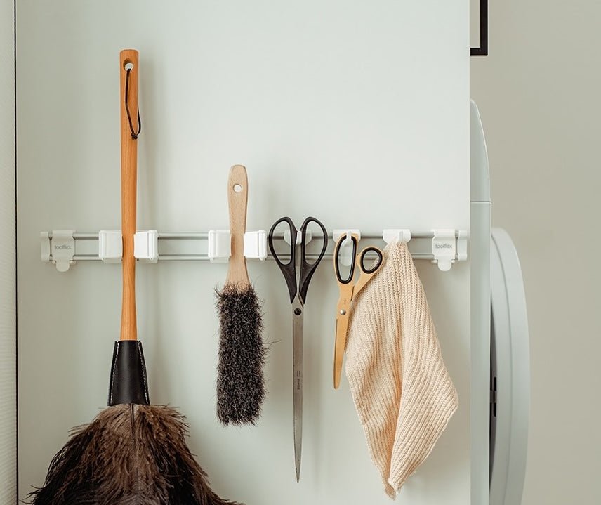 Laundry tools hanging on wall-mounted storage hooks
