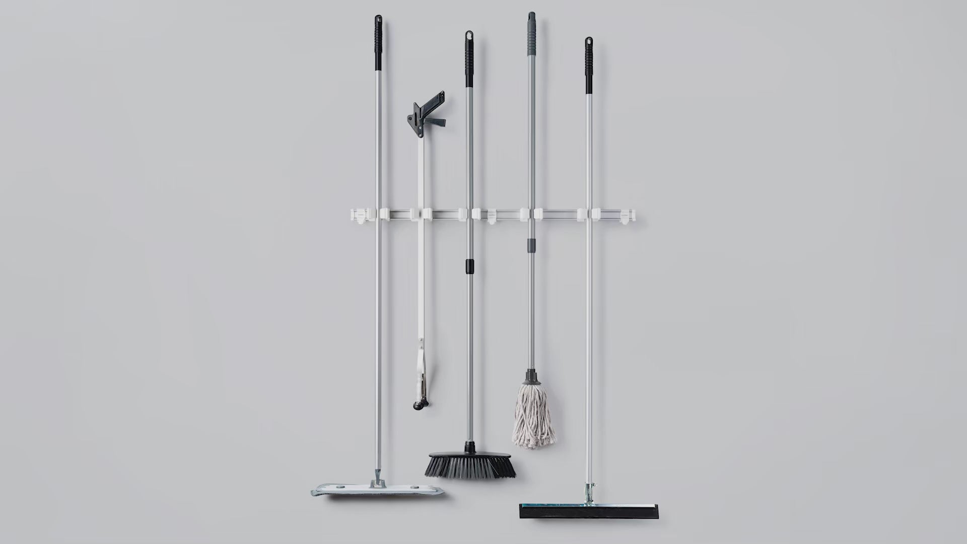 Toolflex One assembly showing holders mounted on rail for wall-mounted tool storage system